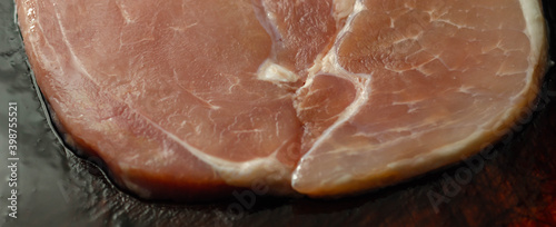 Smoked gammon steak formed from selected cuts of cured pork leg photo