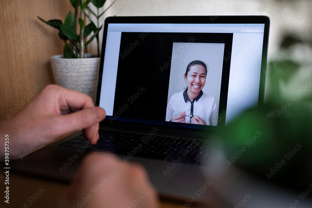 Smiling woman on laptop screen during video call Smiling woman on laptop screen during video call