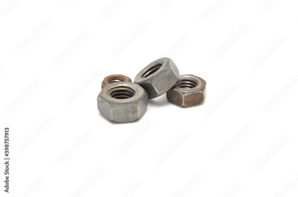 Rusty nuts on a white background close-up. steel, thread, fasteners Rusty nuts on a white background close-up. steel, thread, fasteners