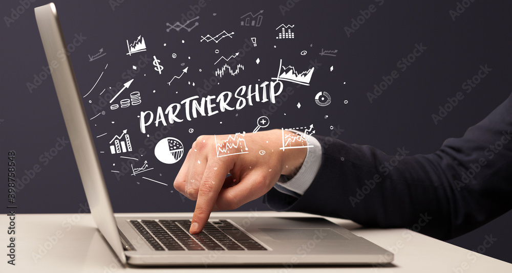 Businessman working on laptop with PARTNERSHIP inscription, modern business concept Businessman working on laptop with PARTNERSHIP inscription, modern business concept
