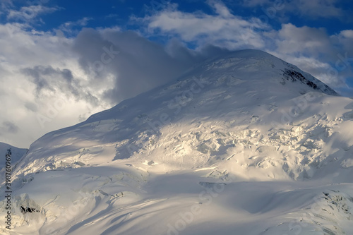 Snow peak in the clouds. Semenov Peak (5816 m), Central Tian Shan, Kyrgyzstan. © Kirill