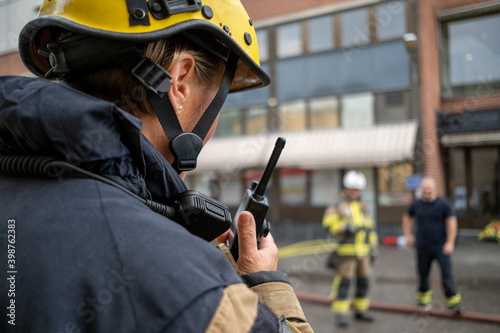 Firefighter talking via walkie talkie