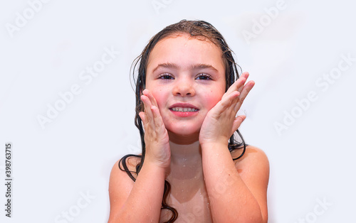 A little girl taking a bath by her own