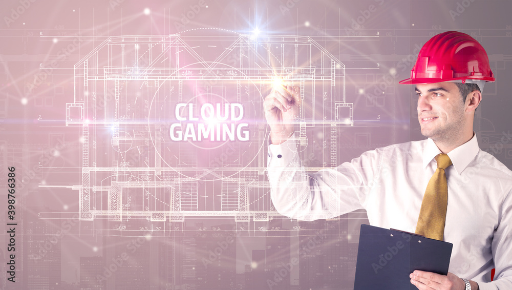 Handsome architect with helmet drawing CLOUD GAMING inscription, new technology concept Handsome architect with helmet drawing CLOUD GAMING inscription, new technology concept