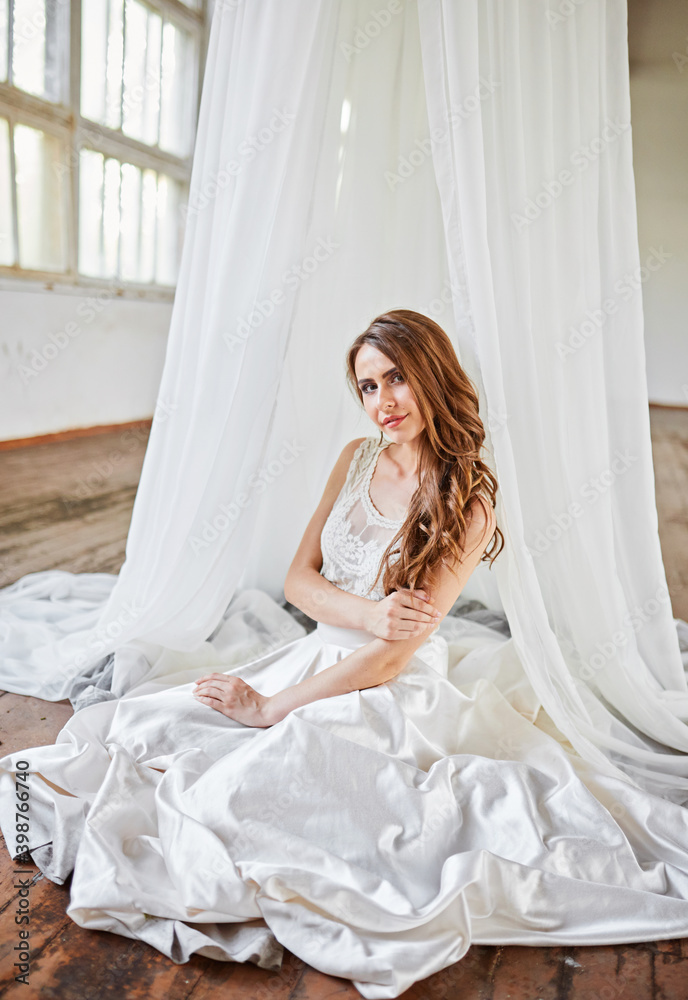 Bride in a white tent in a loft studio Bride in a white tent in a loft studio