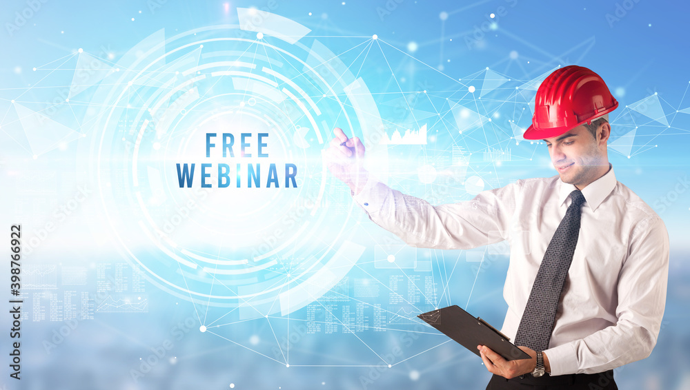 Handsome businessman with helmet drawing FREE WEBINAR inscription, contruction business concept Handsome businessman with helmet drawing FREE WEBINAR inscription, contruction business concept