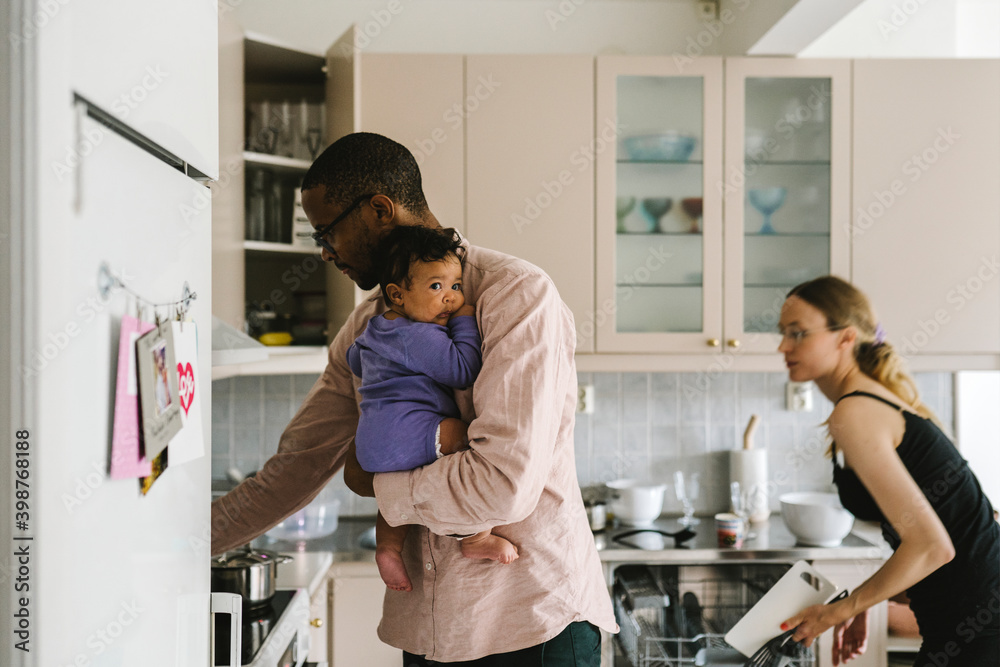 Parents with baby in kitchen Parents with baby in kitchen