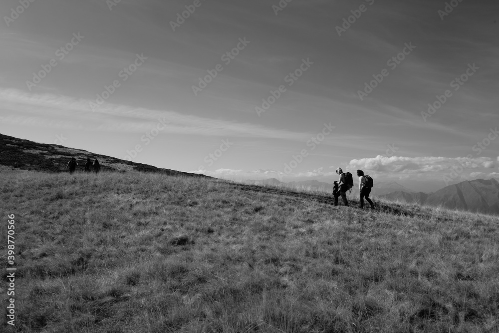 a group of people walking on a hill