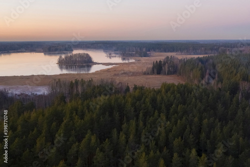 Islands on Lake Vuoksa by the forest in the Leningrad region near the town of Priozersk at sunset in late autumn, aerial view