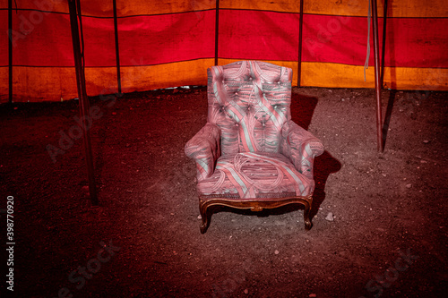 an empty armchair in a circus tent photo