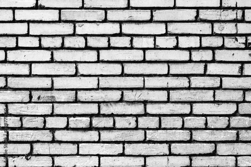 Texture of a brick wall with cracks and scratches which can be used as a background Texture of a brick wall with cracks and scratches which can be used as a background