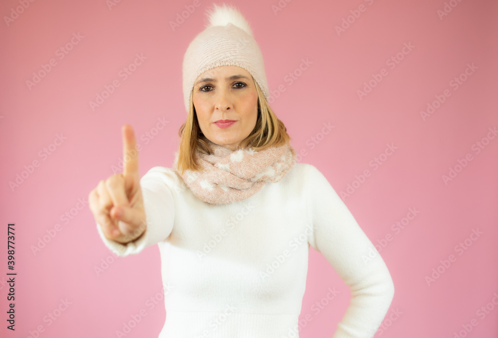 Portrait of a happy young woman wearing casual sweater pointing finger up at copy space isolated over pink background Portrait of a happy young woman wearing casual sweater pointing finger up at copy space isolated over pink background