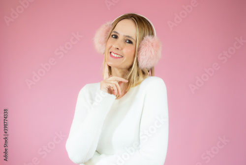 Beautiful young woman smiling isolated over pink background