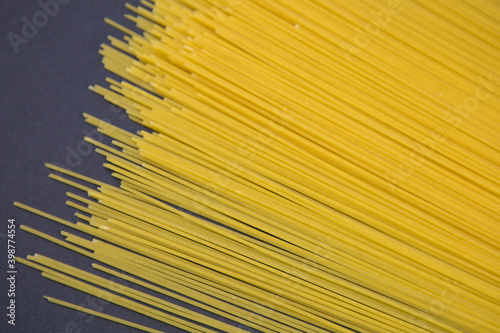 top view of raw Italian spaghetti isolated on dark background