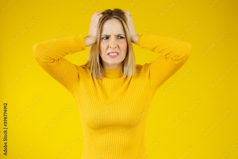 A very frustrated and angry woman pulling her hair. Isolated on white. A very frustrated and angry woman pulling her hair. Isolated on white.