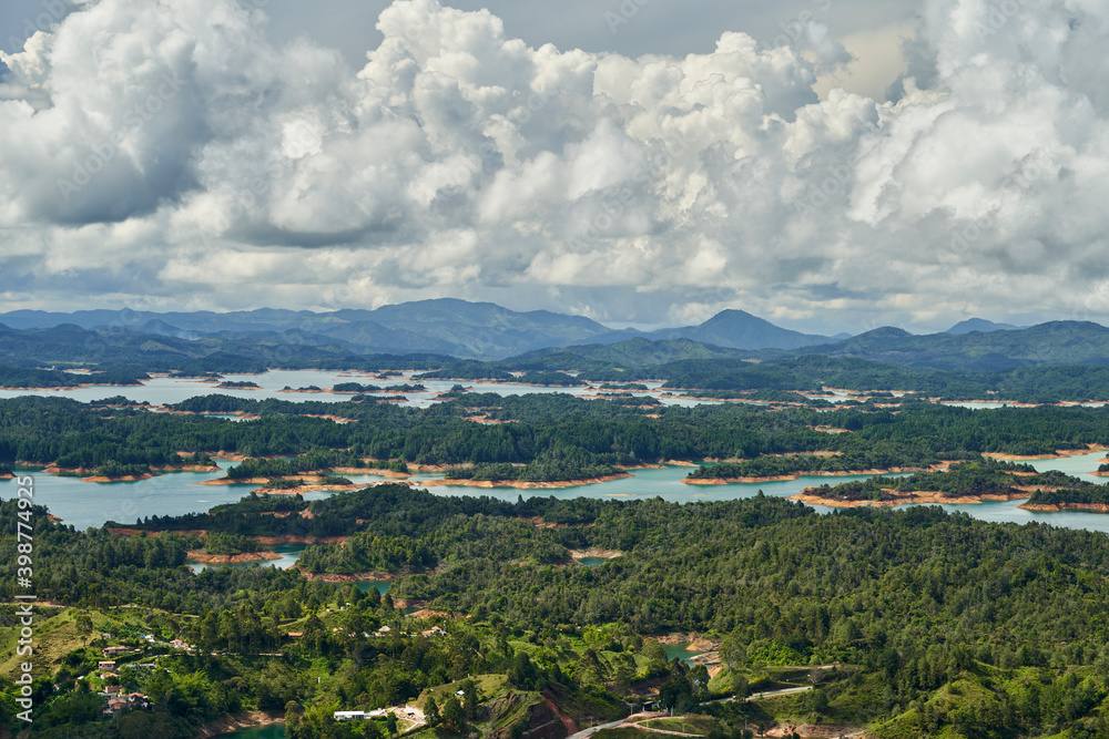 View of Guatape from the top of El Penon onto the artificial lake with its turquoise water and lagoons
