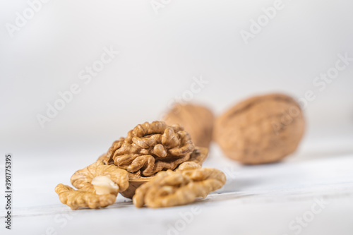 Walnuts kernels on white wooden desk, stock photo