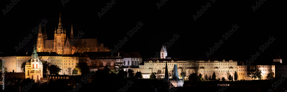 .panorama of night prague illuminated charles bridge on river vltava and prague castle and saint vitus church in center of prague