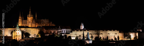 .panorama of night prague illuminated charles bridge on river vltava and prague castle and saint vitus church in center of prague