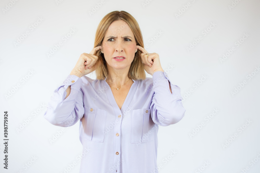 Beautiful young woman gesture do not want to hear holds hands on her ears Beautiful young woman gesture do not want to hear holds hands on her ears