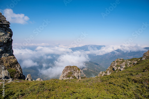 View from the top of Babin zub (The Grandmather's tooth) on Old mountain, which is the most beautiful peak of Stara planina ( Balkan mountains).The impressive and big striking rocks and dense plants. photo