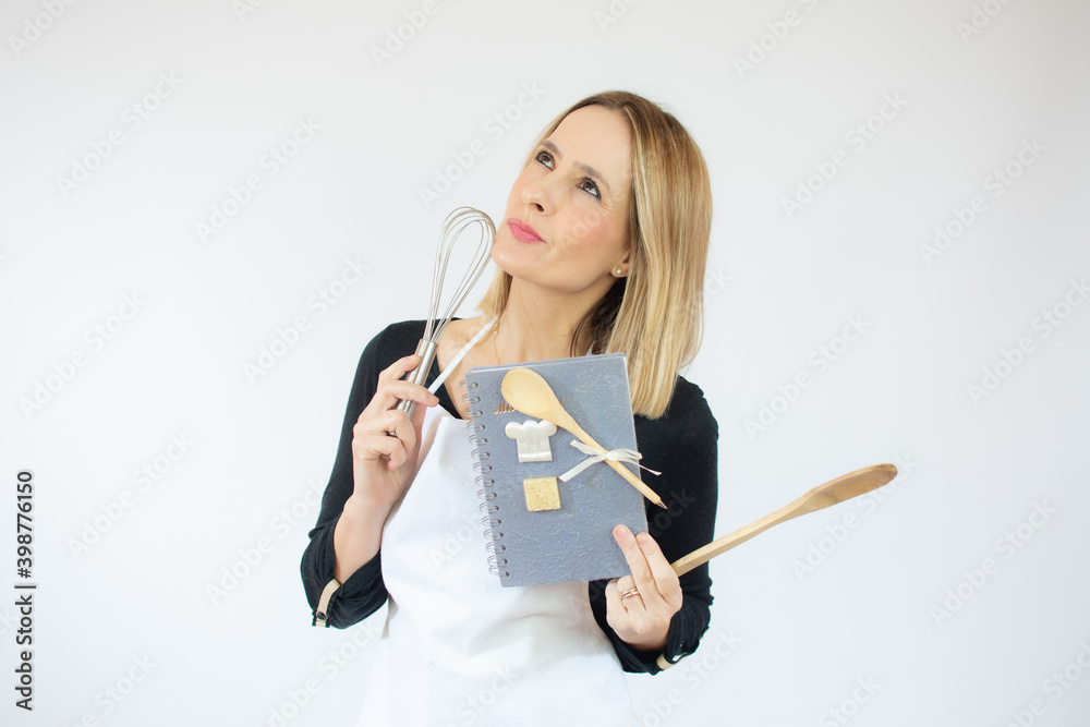 Portrait of young woman wearing apron ready to cook over white background. Portrait of young woman wearing apron ready to cook over white background.