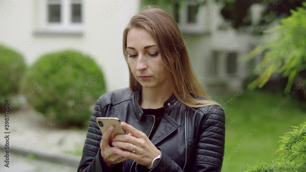 Very focused woman in the mid-thirtis is writing sms on her mobile phone. Very focused woman in the mid-thirtis is writing sms on her mobile phone.