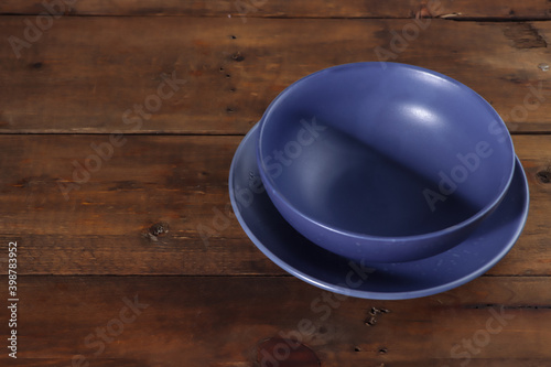 blue bowl on wooden table