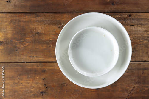 Tableware: white empty plate isolated on the wooden table
