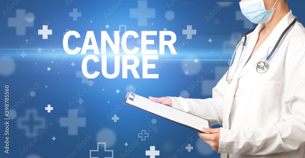 doctor writes notes on the clipboard with CANCER CURE inscription, first aid concept doctor writes notes on the clipboard with CANCER CURE inscription, first aid concept
