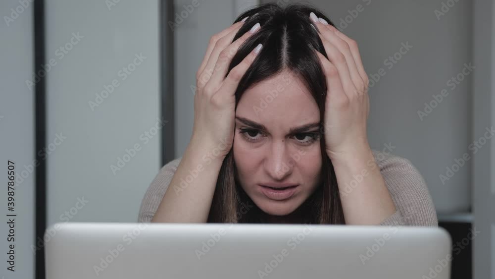 frustrated millennial female student feel stressed look at computer screen worried of problem read bad online news receive failed exam results concept sit at home frustrated millennial female student feel stressed look at computer screen worried of problem read bad online news receive failed exam results concept sit at home