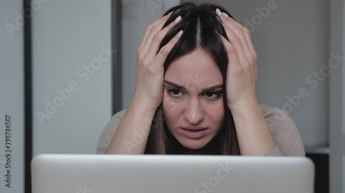 frustrated millennial female student feel stressed look at computer screen worried of problem read bad online news receive failed exam results concept sit at home