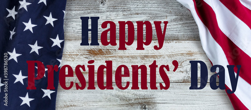 Happy Presidents Day text with cloth US flag on side borders of white rustic wood