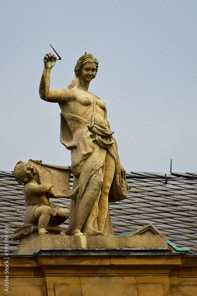 Sculpture of a woman and a child on an old building