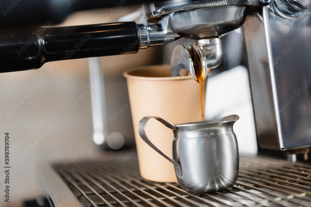 Mug near coffee machine dispenser and paper cup on blurred background Mug near coffee machine dispenser and paper cup on blurred background