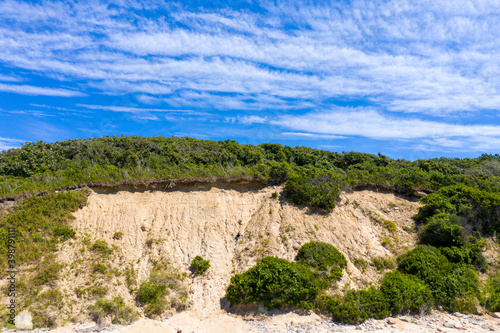 weathered cliff face on shore of island