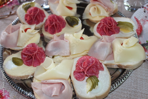 garnished sandwiches on a largeplate on the table photo