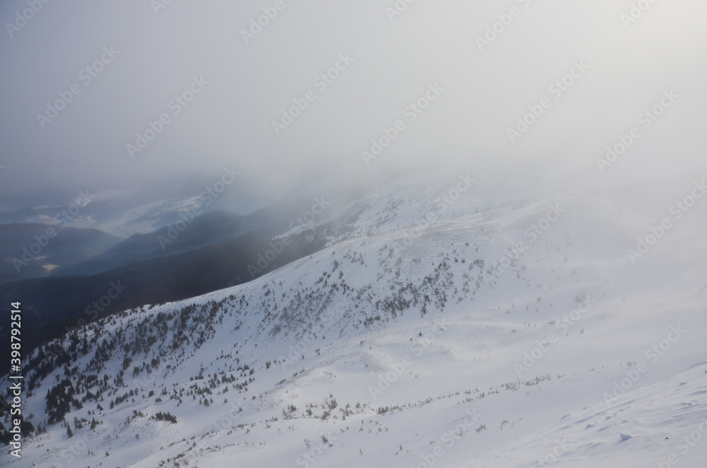 Snowy winter in the Ukrainian Carpathian mountains with foggy weather