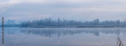 Ukraine, Kyiv - 30 November 2020: Nebrezh Lake at the frozen mist morning weather © vector_master