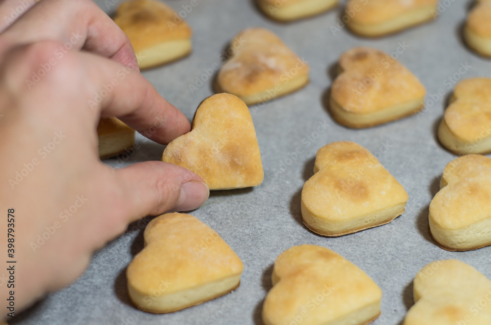 Homemade sweet cookies in the shape of hearts. Home comfort in the kitchen. Cooking with love Homemade sweet cookies in the shape of hearts. Home comfort in the kitchen. Cooking with love