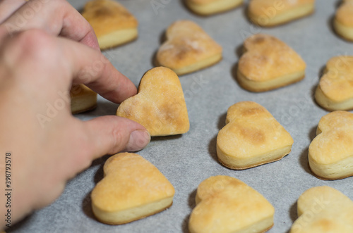 Homemade sweet cookies in the shape of hearts. Home comfort in the kitchen. Cooking with love
