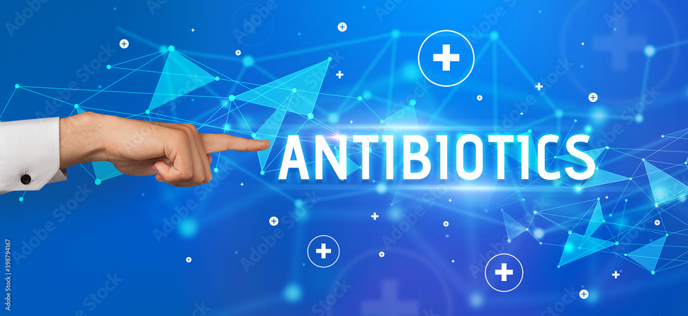 Close-Up of cropped hand pointing at ANTIBIOTICS inscription, medical concept