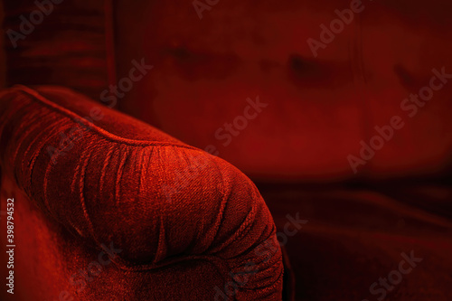 Beautiful classic red velvet luxurious sofa. Burgundy velvet armrest.