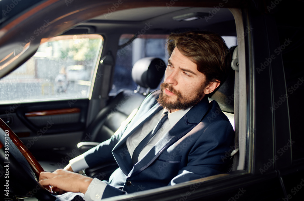 handsome man in suit driving a car trip official lifestyle