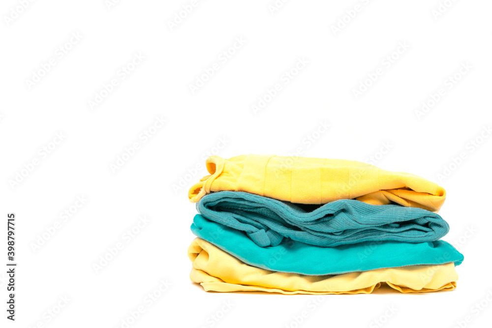 laundry pile of colorful clothing isolated. stack of trendy color clothes close up with copy space