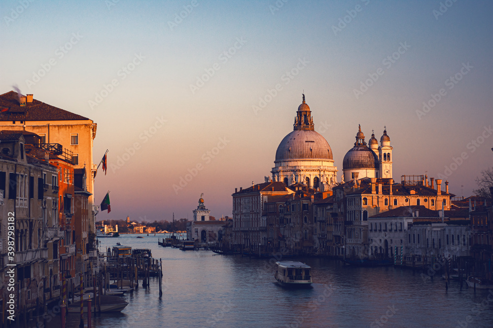 view of the Canal Grand and Basilica of Santa Maria della Salute from the Accademia bridge during covid 19 at sunset 