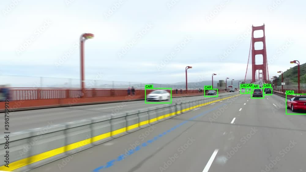 
Autonomous car driving through the Golden Gate Bridge in San Francisco. Computer vision with object detection system that creates boxes to recognize the different objects. Artificial intelligence.