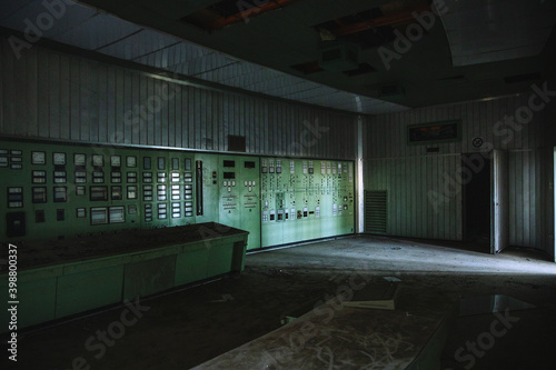 Power station abandoned, forgotten for years, equipment and control tower left out of use. cooling chimneys turned off, spectral building in Italy