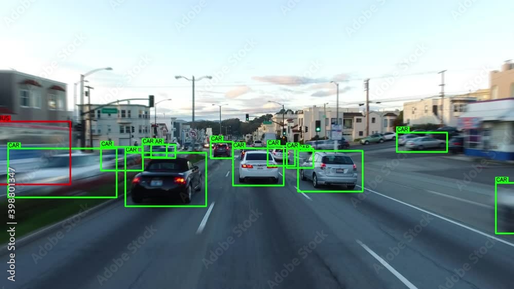 Autonomous car driving through a San Francisco neighborhood. Computer vision with object detection system that creates boxes to recognize the different objects. Artificial intelligence technology.