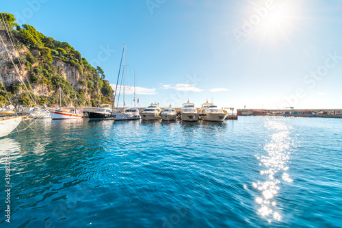 Boats line the Fontvieille Harbor near the Rock of Monaco as the sun starts to set on the Mediterranean Sea.